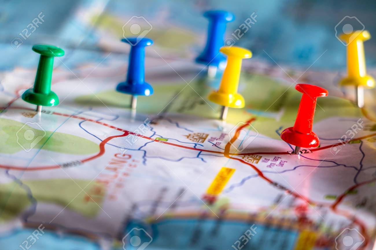 travel destination pin points on a map with colorful thumbtacks