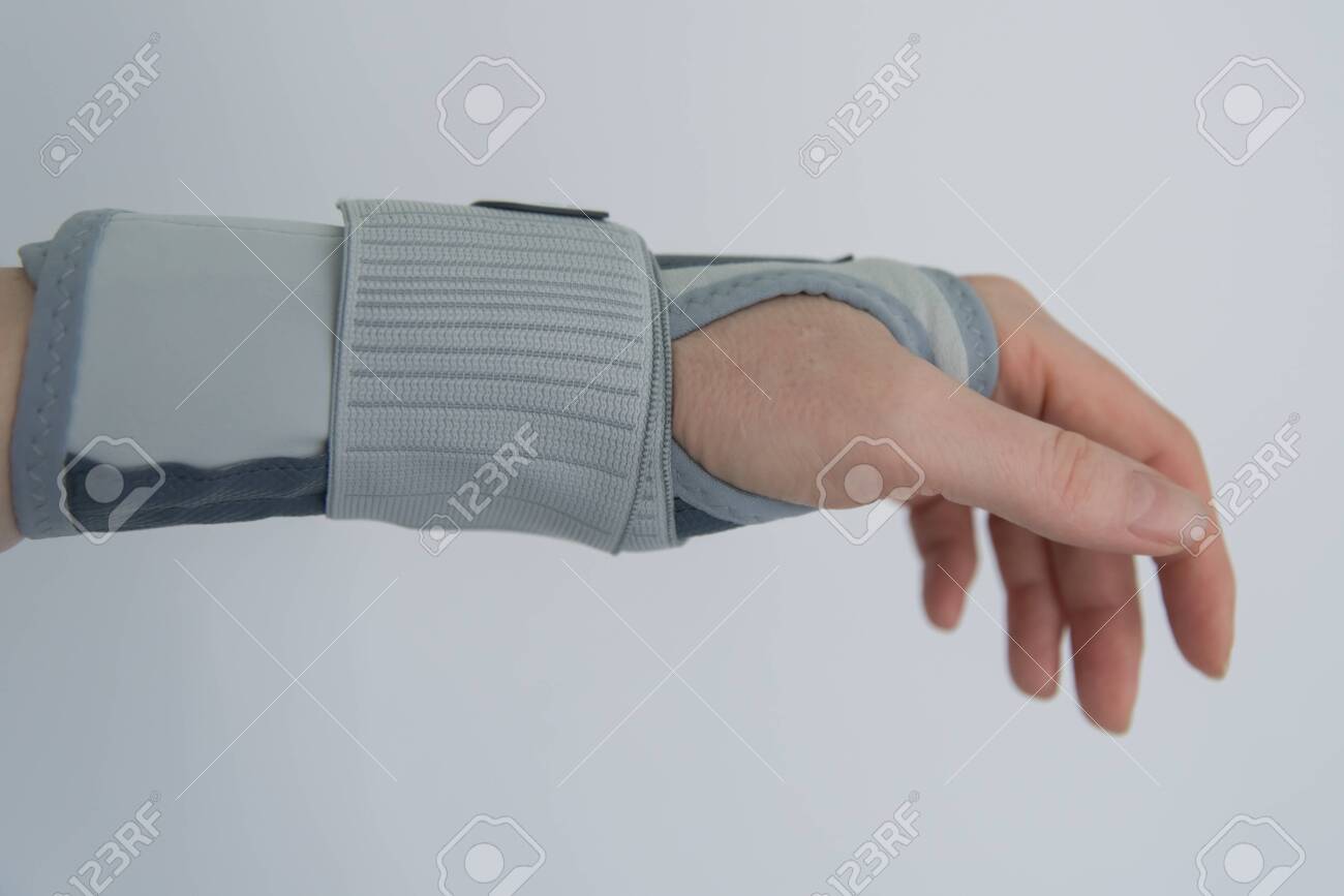 Female hand with orthosis, recovery and treatment with modern orthosis. - 143951798 Female hand with orthosis, recovery and treatment with modern orthosis. - 143951798