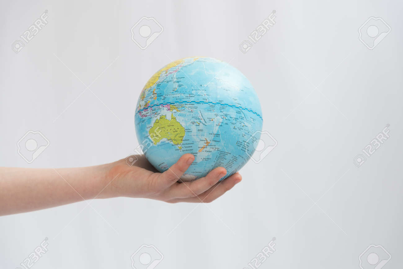 Childrens hands carefully hold the globe. Concept. Our land is in the hands of the future generation - 167359879 Childrens hands carefully hold the globe. Concept. Our land is in the hands of the future generation - 167359879
