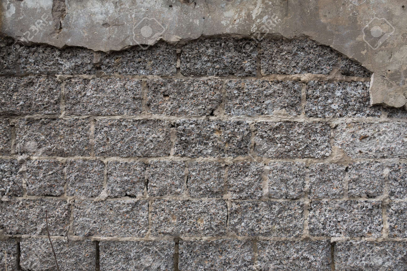 The texture of the old wall from a cement block. Rough gray surface. Concrete structure - 168593739 The texture of the old wall from a cement block. Rough gray surface. Concrete structure - 168593739