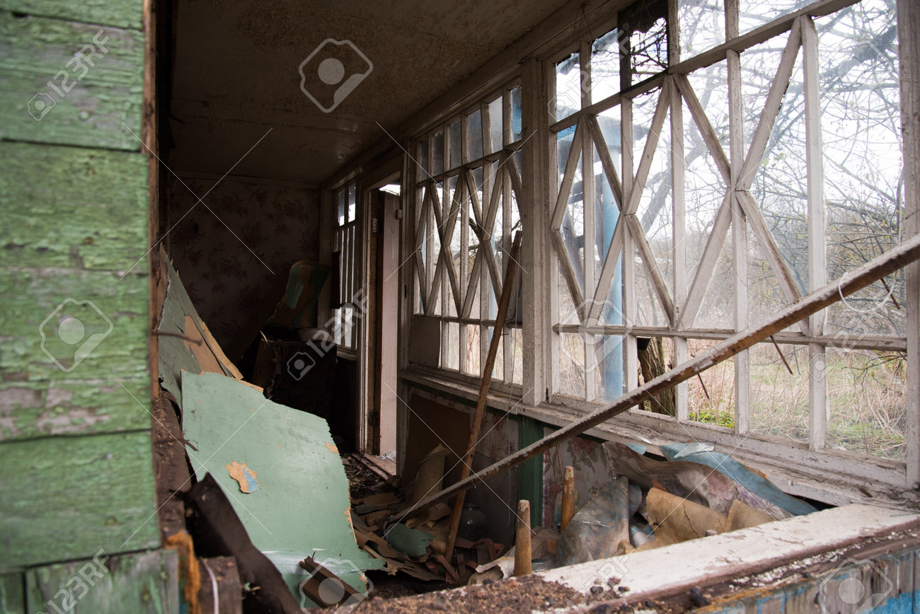 An old abandoned house with broken windows. Destruction concept. Broken glass and mess - 168593807 An old abandoned house with broken windows. Destruction concept. Broken glass and mess - 168593807