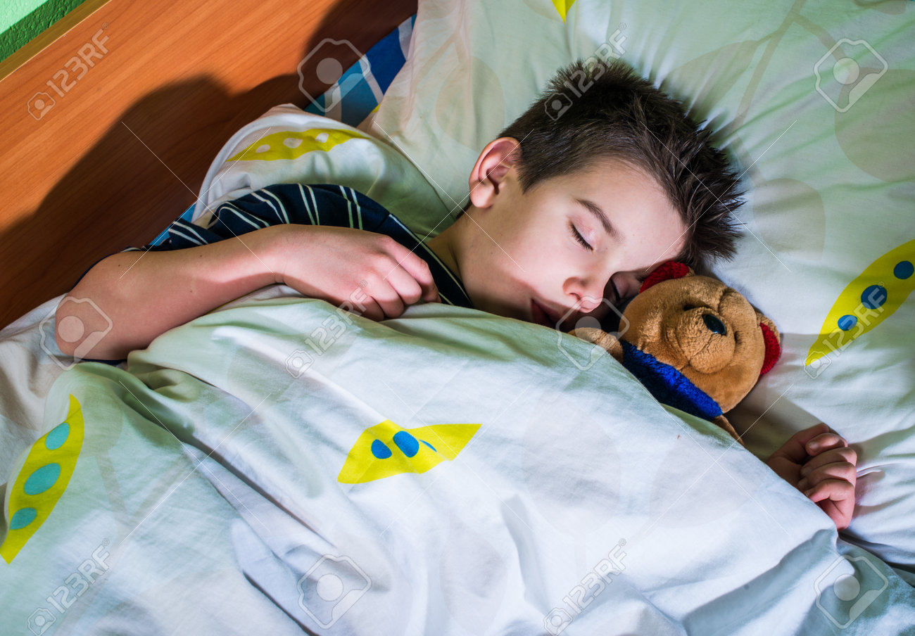 Sleeping child with his toy bear. - 25631272 Sleeping child with his toy bear. - 25631272