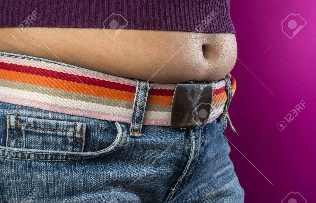 Woman with jeans shows her belly. Overweight. - 34437992 Woman with jeans shows her belly. Overweight. - 34437992