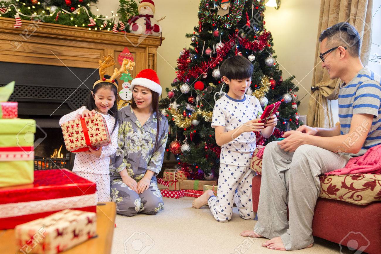 Christmas Morning Presents Opening 2022 Chinese Family Opening Presents Together On Christmas Morning. They Are All  Sitting In The Front Room In Their Pyjamas, In Front Of The Tree. Stock  Photo, Picture And Royalty Free Image. Image