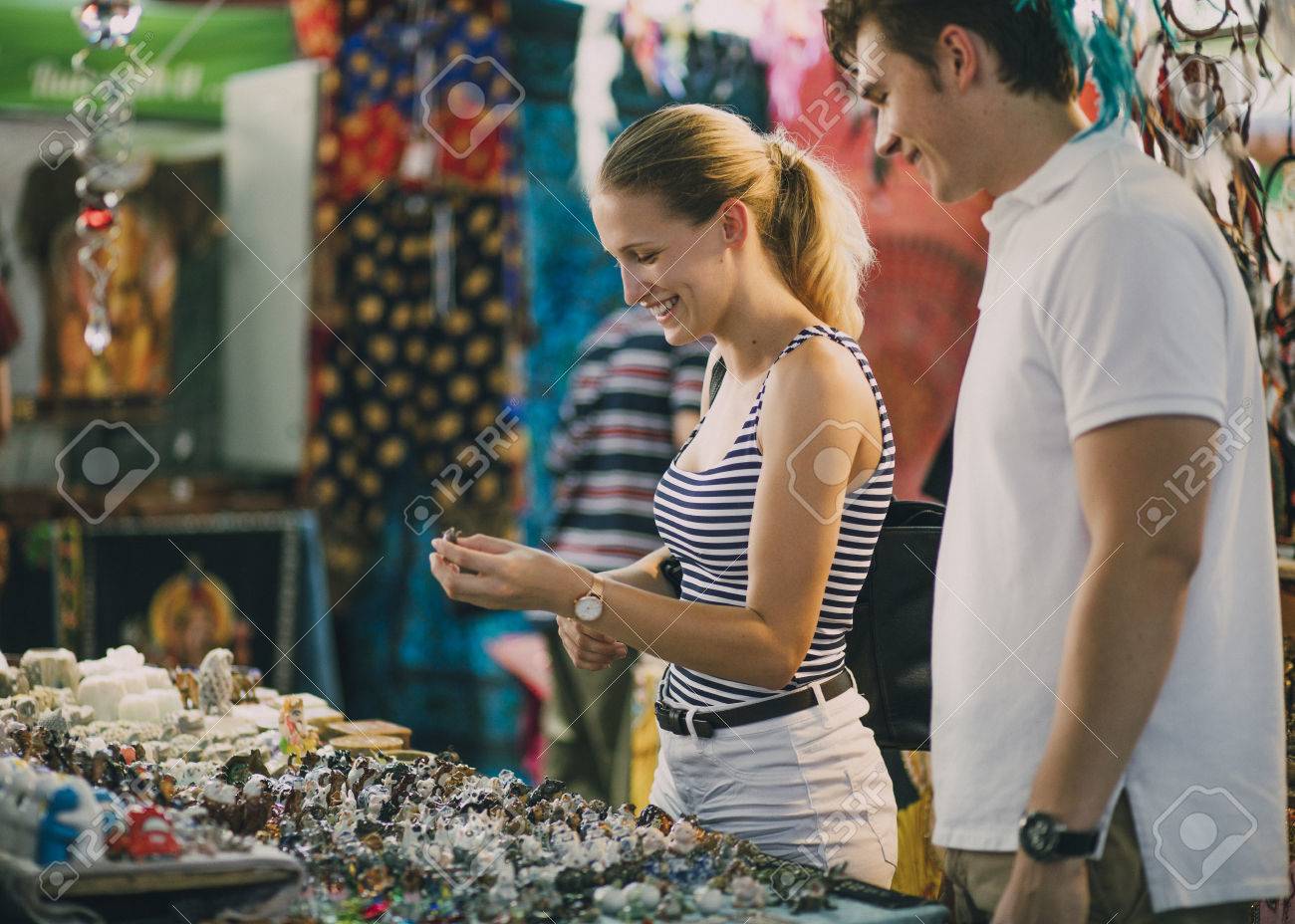 Young couple are looking at a jewellery stall in Queen Victoria Market, Australia. - 80779685 Young couple are looking at a jewellery stall in Queen Victoria Market, Australia. - 80779685