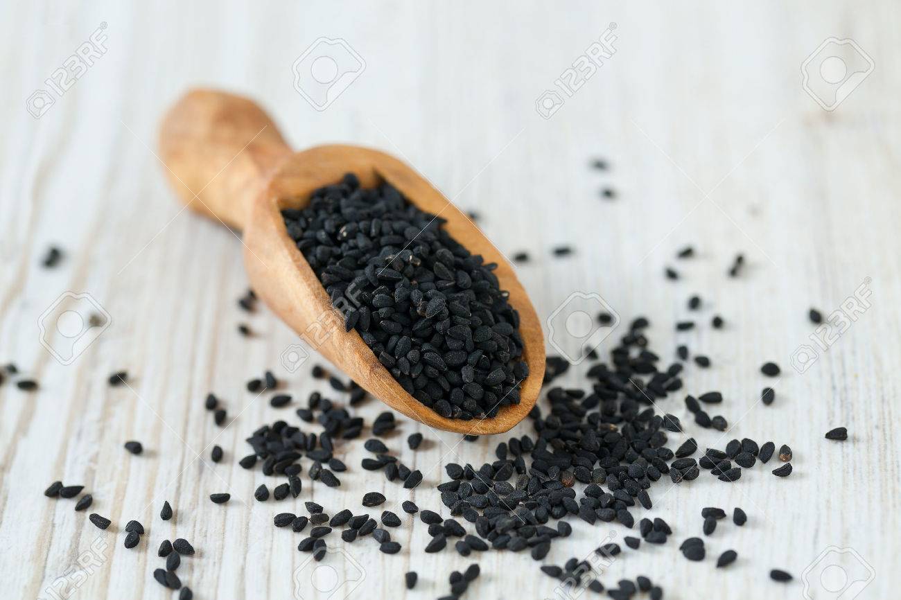 black cumin on wooden surface - 53250198 black cumin on wooden surface - 53250198
