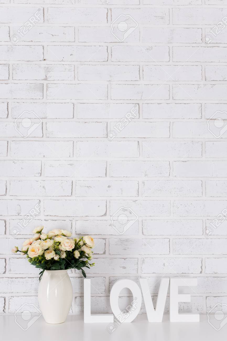 White Wooden Word Love And Flowers Over White Brick Wall Background Stock Photo Picture And Royalty Free Image Image 81202696