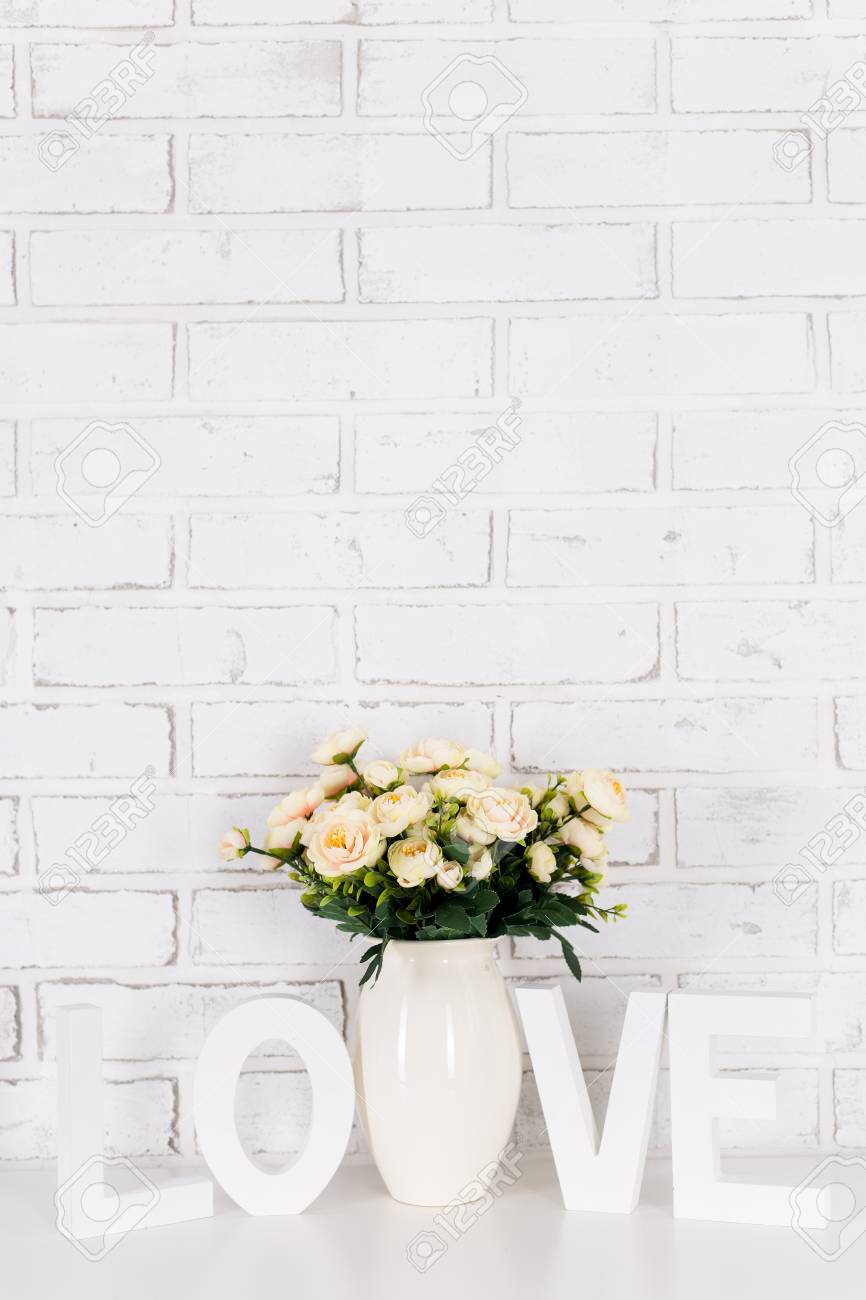 Rose Flowers And Wooden Word Love Over White Brick Wall Background Stock Photo Picture And Royalty Free Image Image 85882353