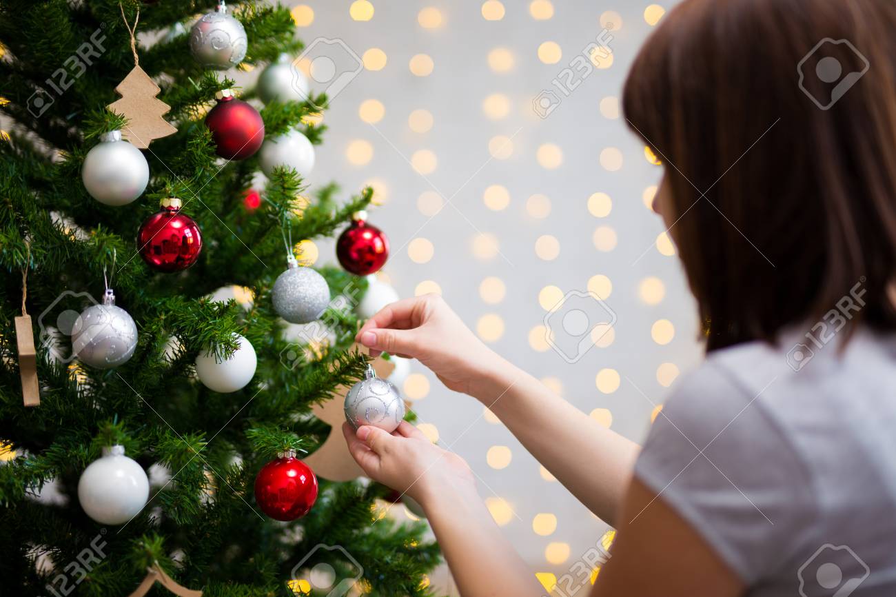 girl decorating christmas tree