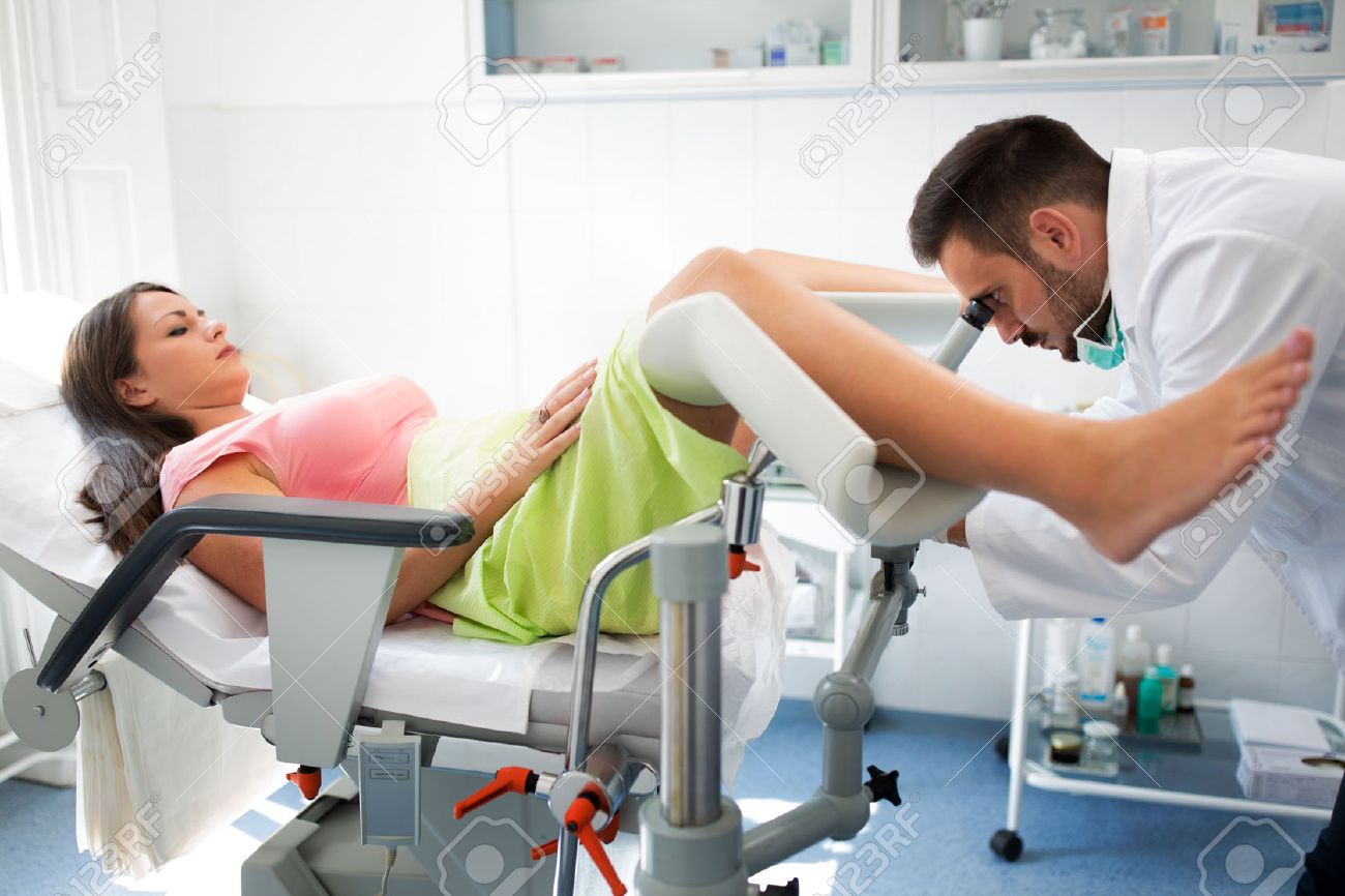 gynecologist examining a patient with a colposcope check up stock