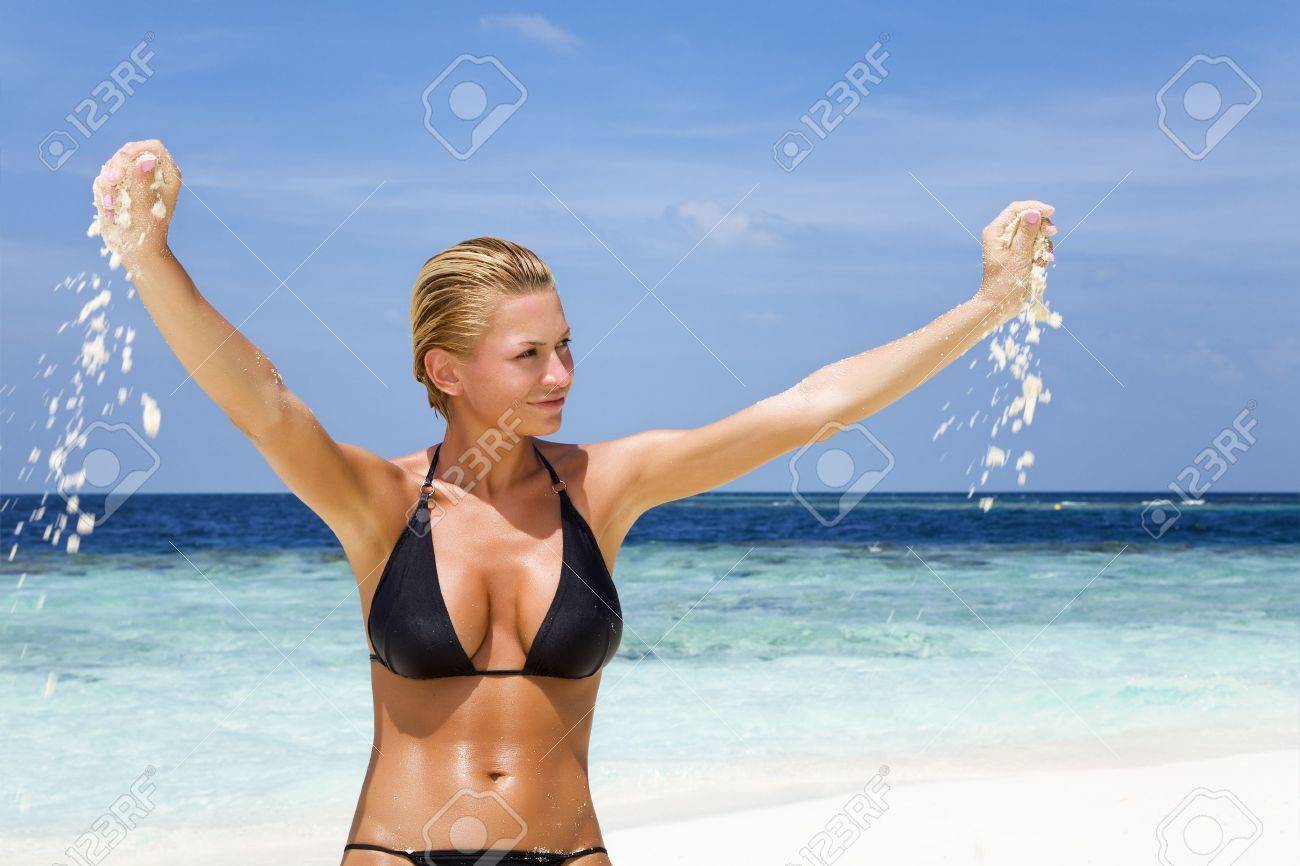 Tropical Beach: Perfect Girl Playing With Sand On A Tropical Beach  Фотография, картинки, изображения и сток-фотография без роялти. Image  2441025
