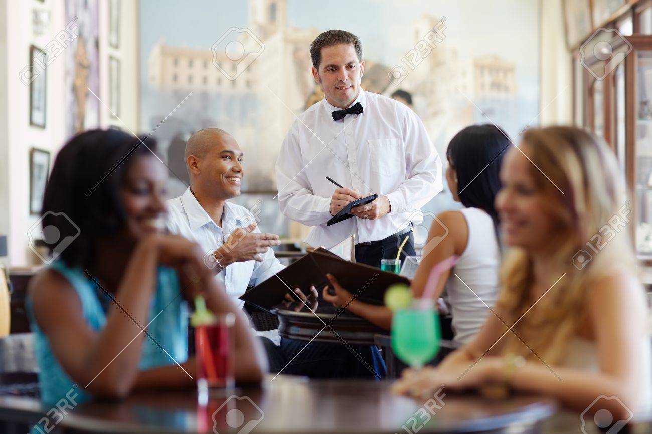 young adult hispanic couple dining out in restaurant and talking to waiter in bow tie. Horizontal shape, front view, waist up - 9626175 young adult hispanic couple dining out in restaurant and talking to waiter in bow tie. Horizontal shape, front view, waist up - 9626175