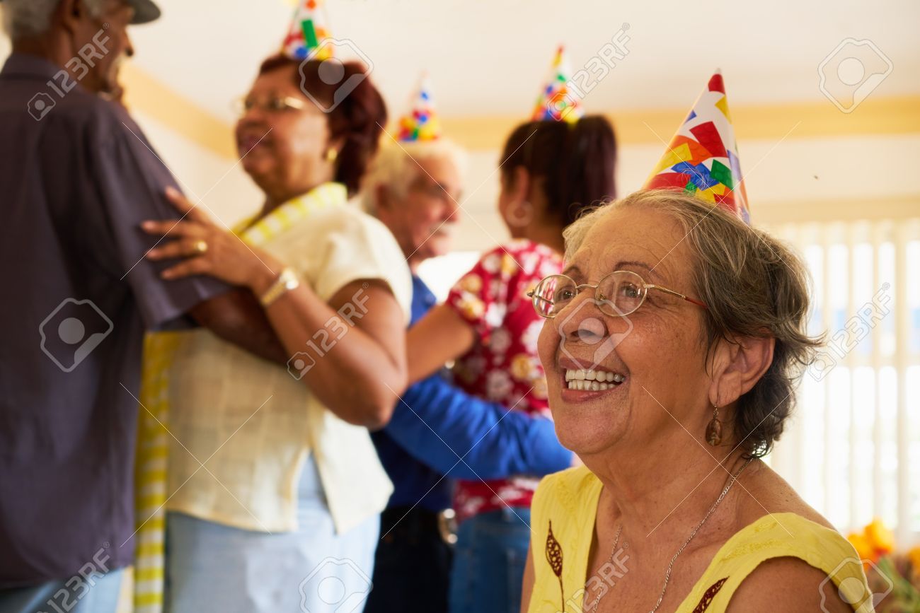 Group of old friends and family celebrating senior birthday party in retirement home. Patient woman smiling in hospice. - 66578638 Group of old friends and family celebrating senior birthday party in retirement home. Patient woman smiling in hospice. - 66578638