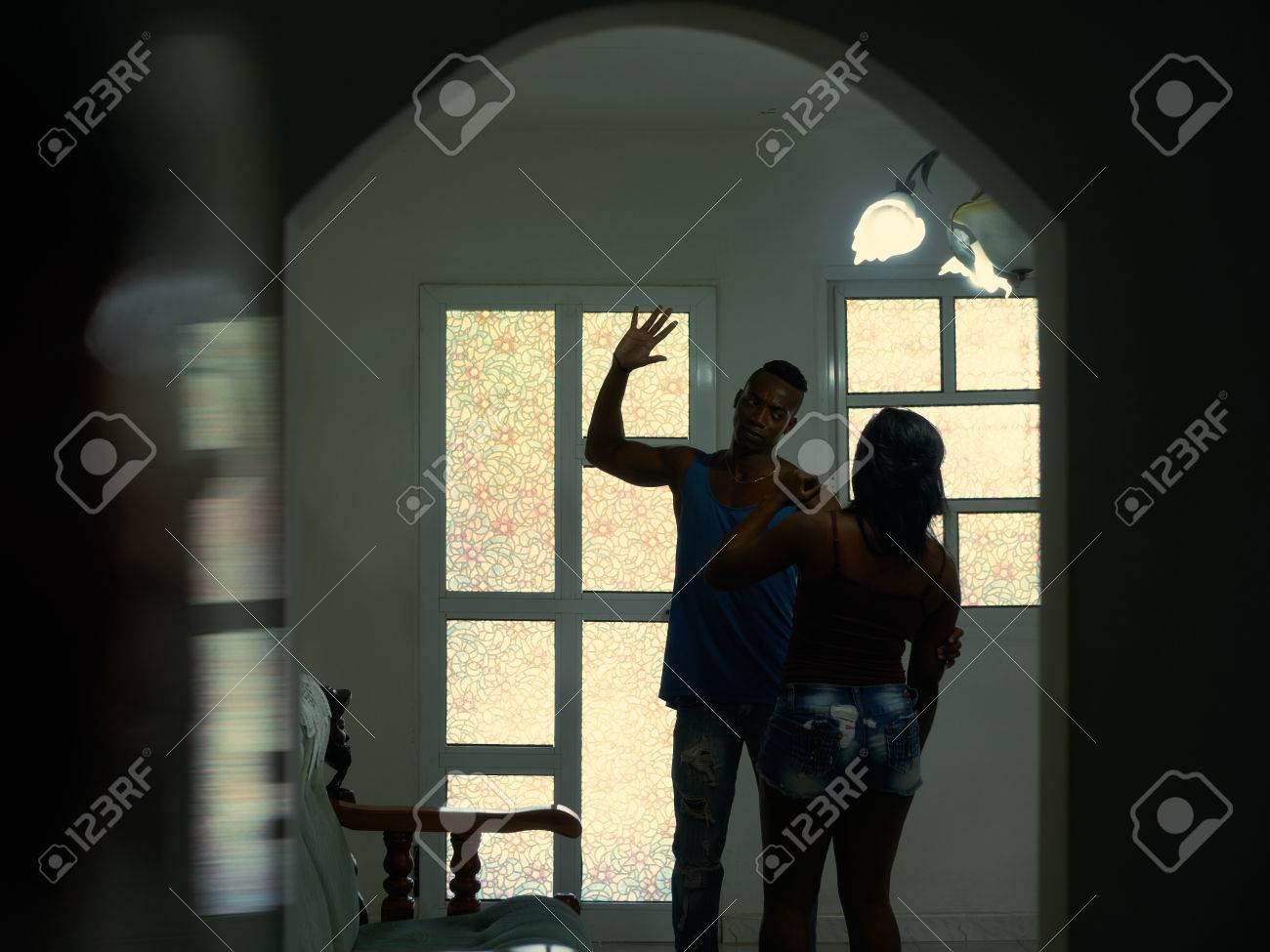 Social issues, aggression and violence on women, alcoholic black man hitting and beating woman at home. Domestic fight with aggressive husband and abused wife crying - 72344313 Social issues, aggression and violence on women, alcoholic black man hitting and beating woman at home. Domestic fight with aggressive husband and abused wife crying - 72344313
