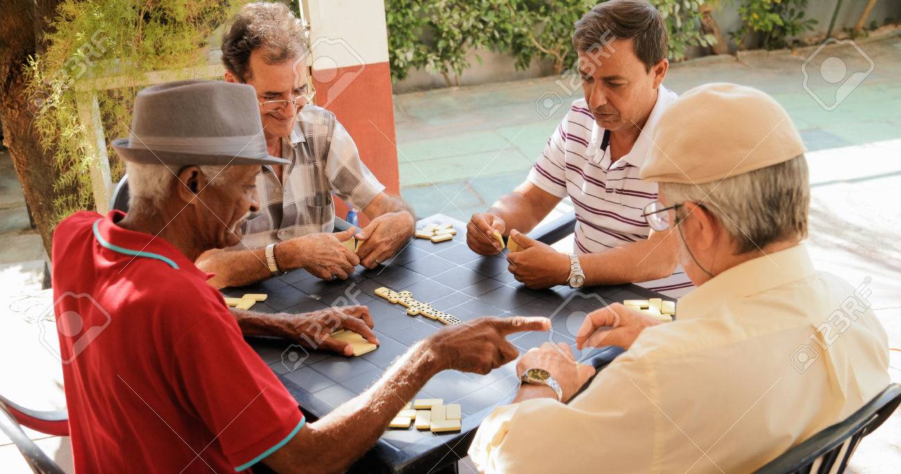 Retired people, seniors and free time. Old latino men having fun and playing game of domino in Cuba. - 82752065 Retired people, seniors and free time. Old latino men having fun and playing game of domino in Cuba. - 82752065