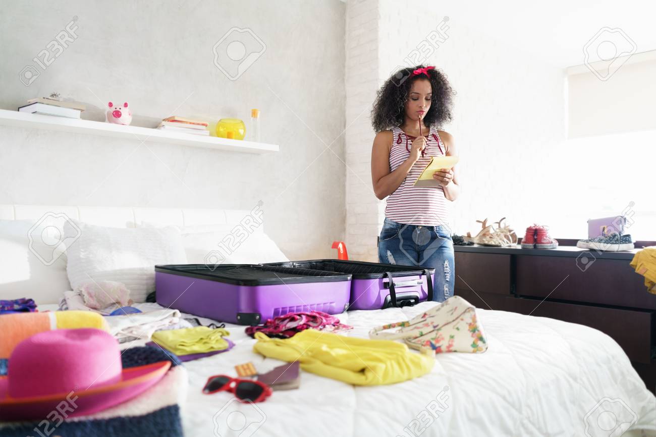 Cute African American Girl Packing Bag For Holiday And Travel - 103955712 Cute African American Girl Packing Bag For Holiday And Travel - 103955712