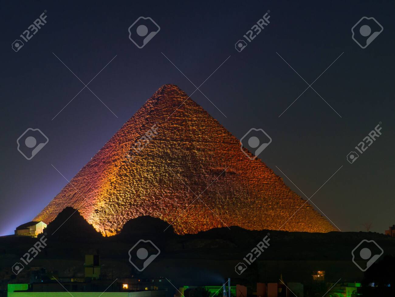 Cairo, Egypt - November 31, 2019: View of the Great Pyramid of Giza illuminated at night. - 151449162 Cairo, Egypt - November 31, 2019: View of the Great Pyramid of Giza illuminated at night. - 151449162