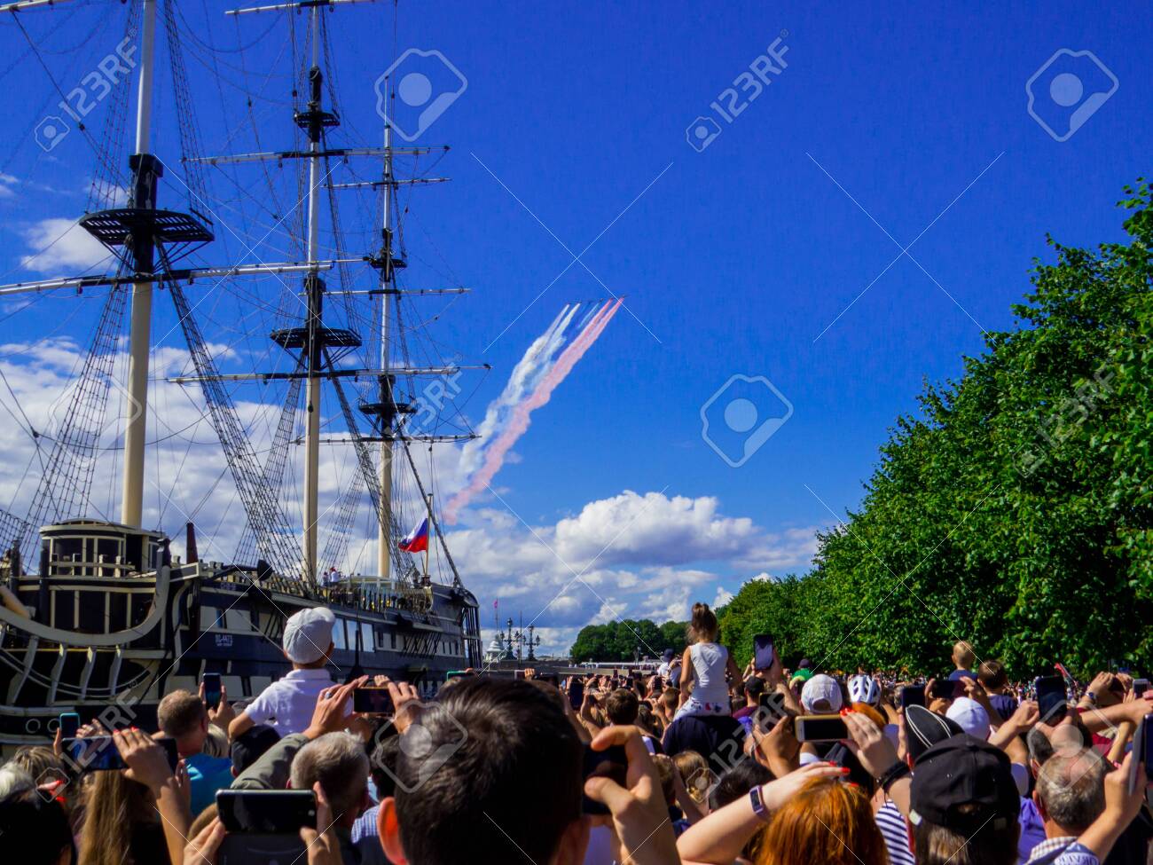 St. Petersburg, Russia - July 26, 2020: People watching the annual celebrations for the Navy Day on the embankment of the Neva River. - 152365072 St. Petersburg, Russia - July 26, 2020: People watching the annual celebrations for the Navy Day on the embankment of the Neva River. - 152365072