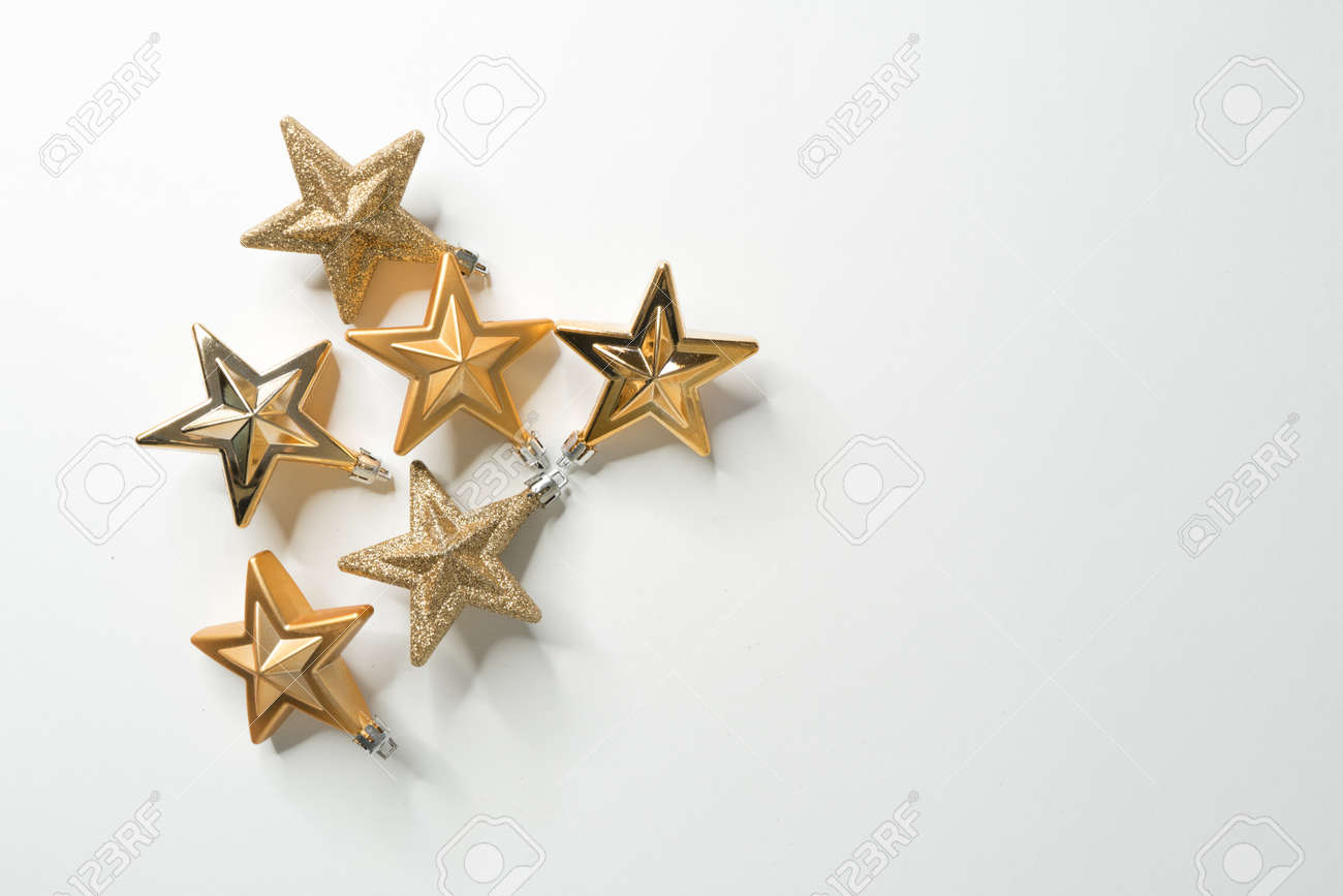 Golden christmas stars on white background - 157609552 Golden christmas stars on white background - 157609552