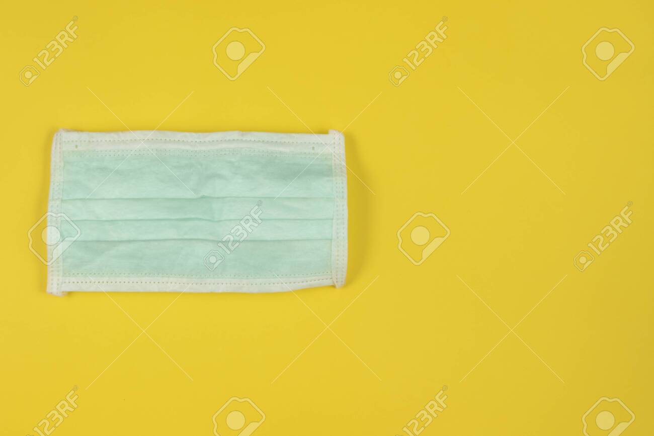Download Medical Face Mask On Yellow Background White And Green Medical Stock Photo Picture And Royalty Free Image Image 144008546 PSD Mockup Templates