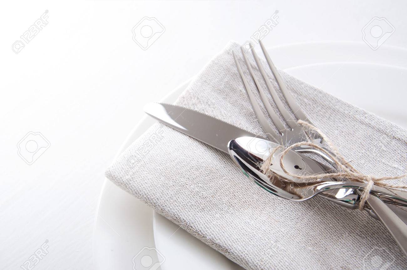 Table Setting In White And Gray Colors With Linen Napkins And ... Table Setting In White And Gray Colors With Linen Napkins And ...