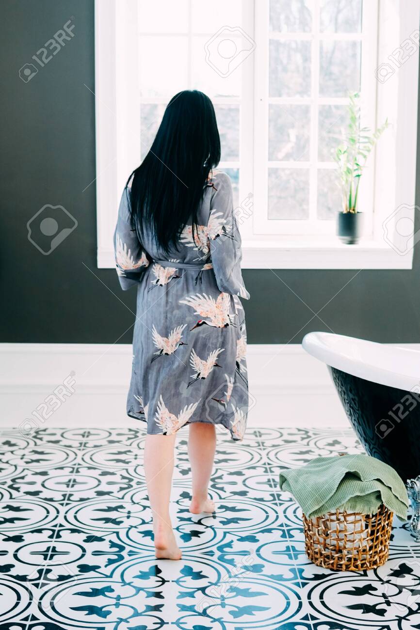 Young Brunette With Long Black Hair And Green Eyes Getting Ready