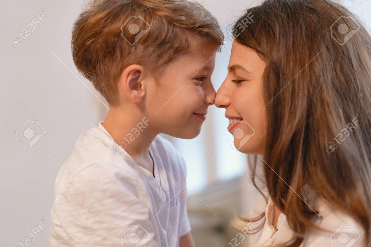 Close Up Portrait Of Smiling Young Mother And Her Preschool Son