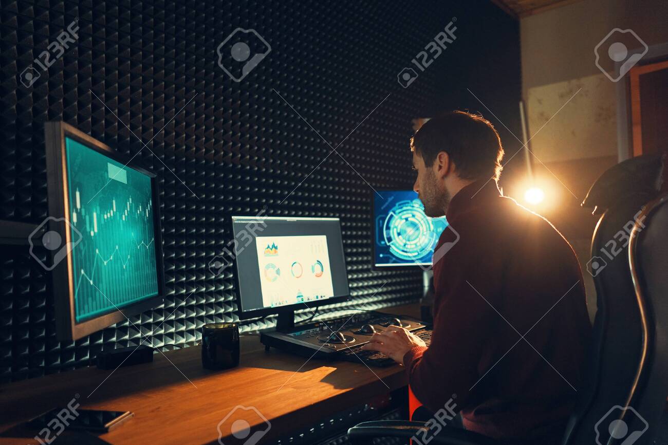 Confident Man Video Editor Works with Footage in Creative Office Studio with light in background. - 126669611 Confident Man Video Editor Works with Footage in Creative Office Studio with light in background. - 126669611