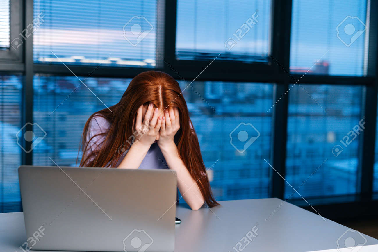 Close-up face of frustrated lonely young woman crying thinking of grief troubled in dark room near window at night. depressed female thinking about mistakes at home office. - 169892842 Close-up face of frustrated lonely young woman crying thinking of grief troubled in dark room near window at night. depressed female thinking about mistakes at home office. - 169892842