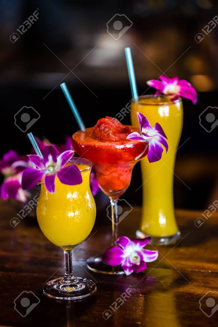 Composition With 3 Yellow And Red Cocktails And Orchid Flowers Stock Photo Picture And Royalty Free Image Image