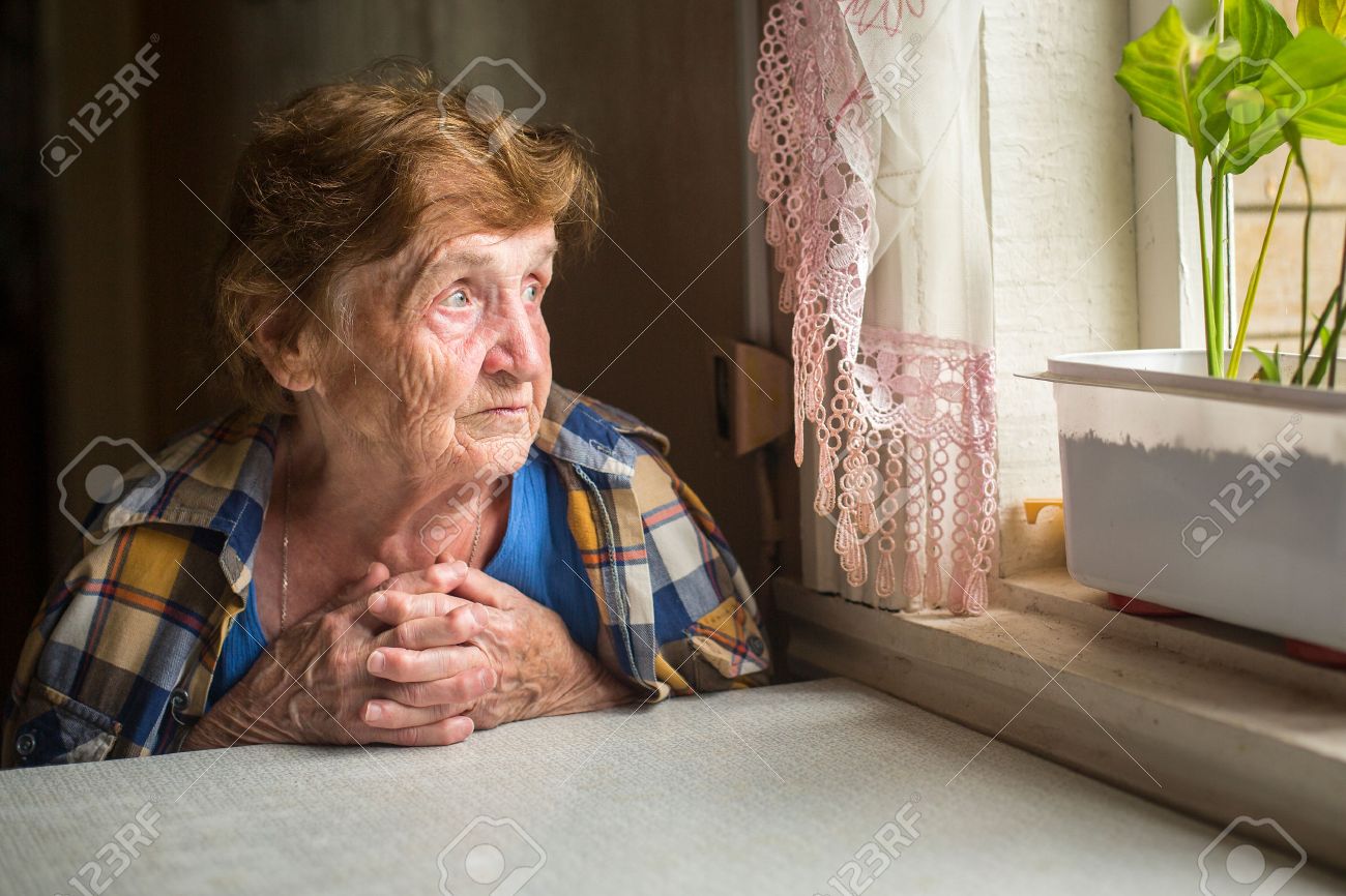 Old lonely woman sitting near the window in his house. - 32704813 Old lonely woman sitting near the window in his house. - 32704813