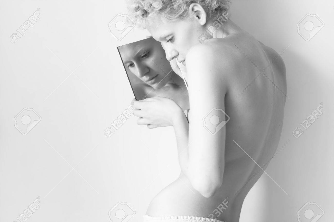 Chica en el espejo con luz tenue sexy