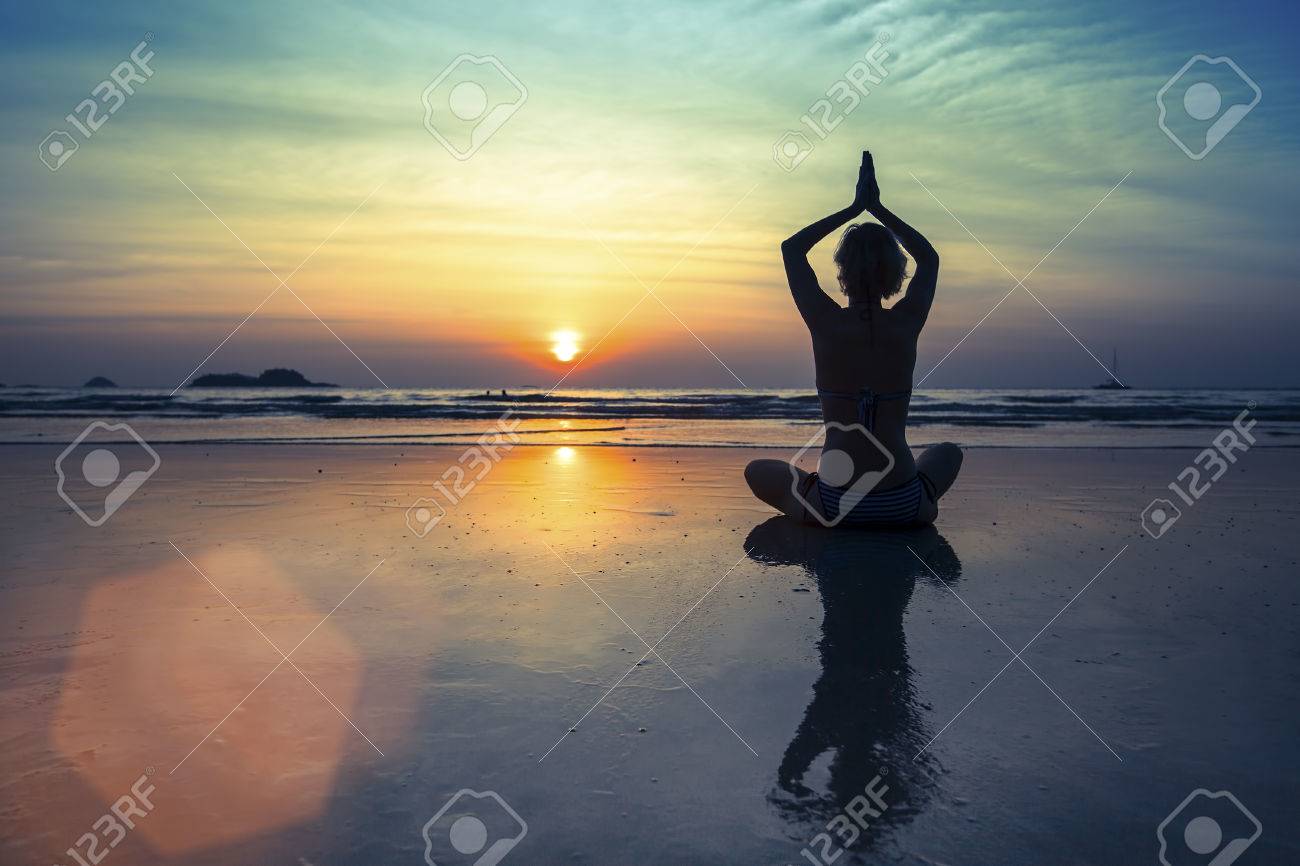 Female silhouette in Yoga meditation pose at amazing sunset. - 38677834 Female silhouette in Yoga meditation pose at amazing sunset. - 38677834