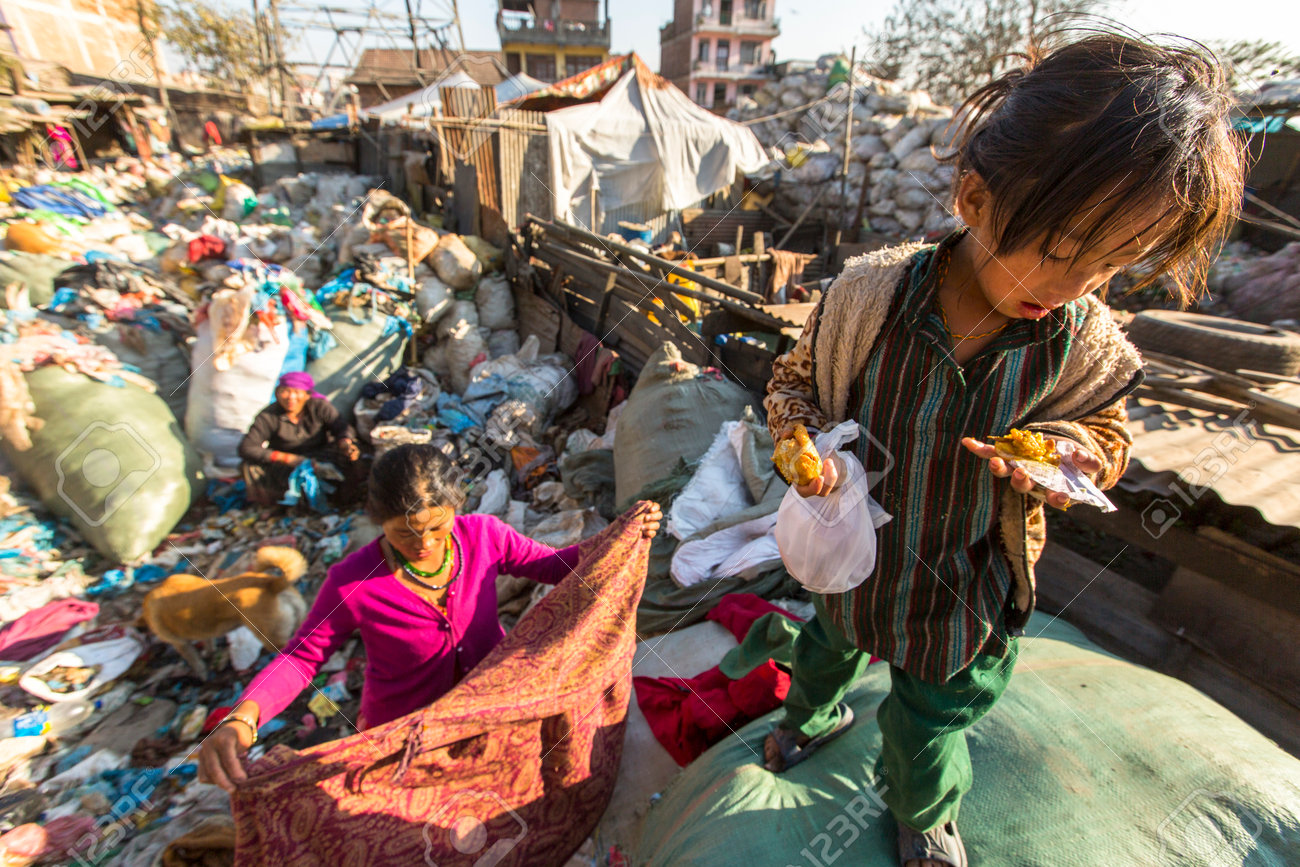 KATHMANDU, NEPAL - CIRCA DEC, 2013: Unidentified child and his parents during lunch in break between working on dump. Only 35% of population Nepal have access to adequate sanitation. - 39326288 KATHMANDU, NEPAL - CIRCA DEC, 2013: Unidentified child and his parents during lunch in break between working on dump. Only 35% of population Nepal have access to adequate sanitation. - 39326288