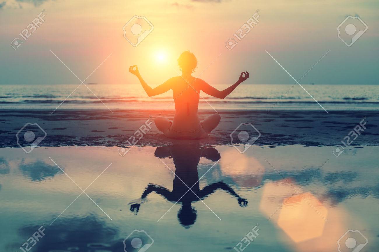 Silhouette meditation girl on the background of the stunning sea and sunset. Yoga, fitness and healthy lifestyle. - 39575631 Silhouette meditation girl on the background of the stunning sea and sunset. Yoga, fitness and healthy lifestyle. - 39575631