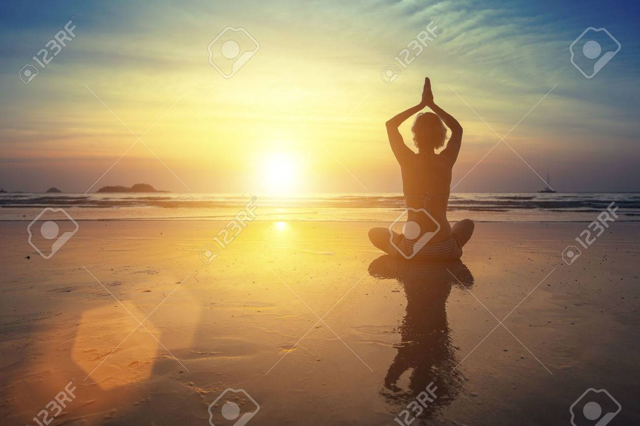 Young woman practicing yoga on the beach at amazing sunset (with reflection) - 44814476 Young woman practicing yoga on the beach at amazing sunset (with reflection) - 44814476