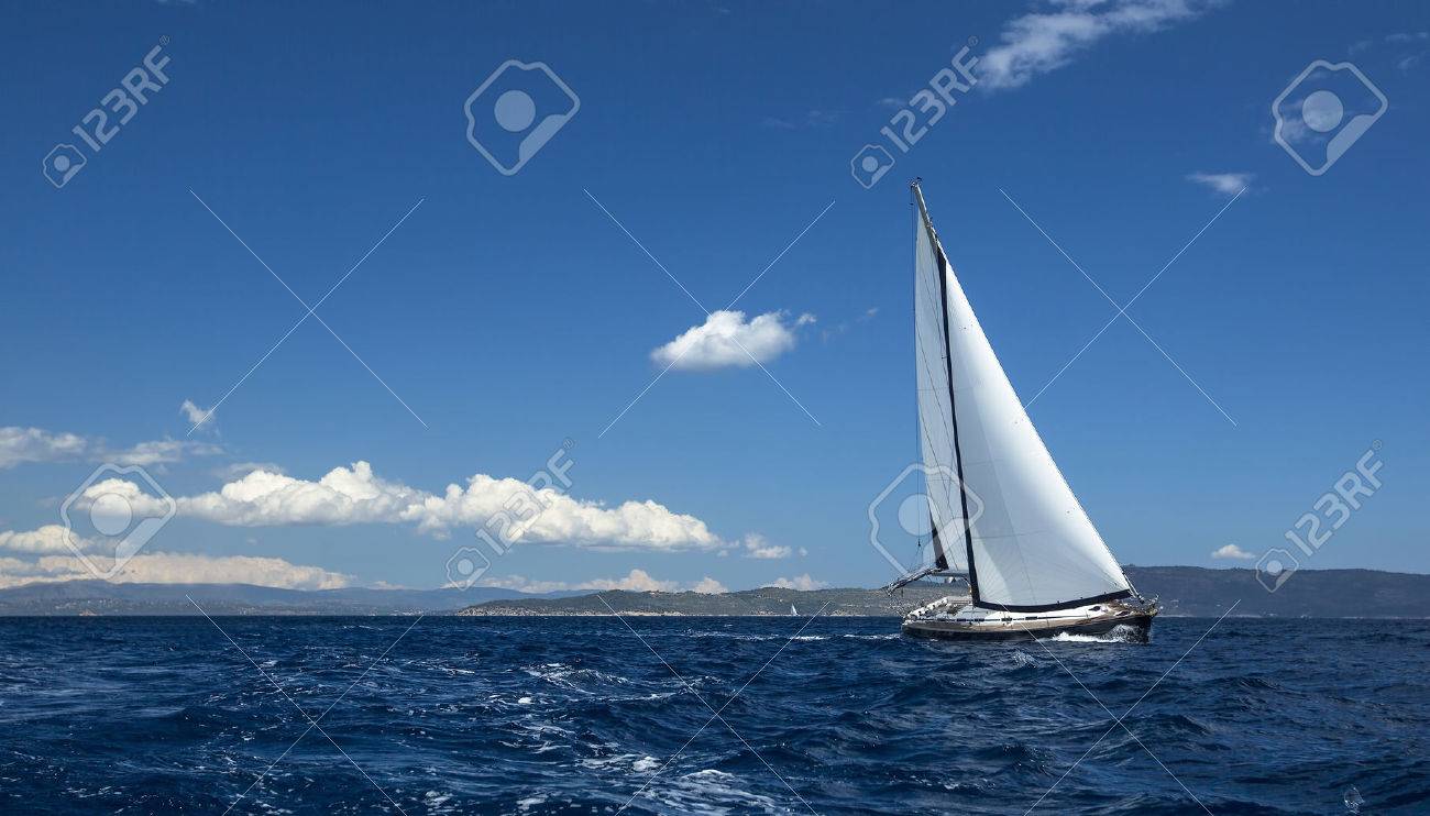 Ship yachts with white sails in the open Sea. Sailing luxury boats. - 46729041 Ship yachts with white sails in the open Sea. Sailing luxury boats. - 46729041