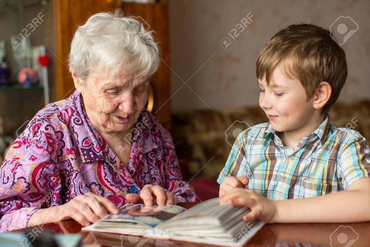 Grandmother and grandson looking photo album. - 57049000 Grandmother and grandson looking photo album. - 57049000