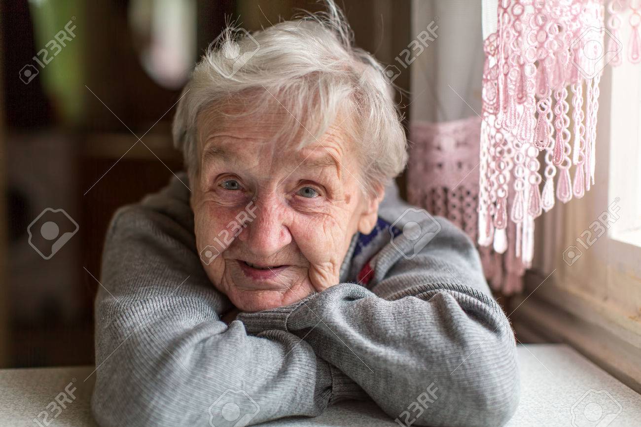Portrait of an elderly woman, close-up, sitting at the table. - 59139897 Portrait of an elderly woman, close-up, sitting at the table. - 59139897