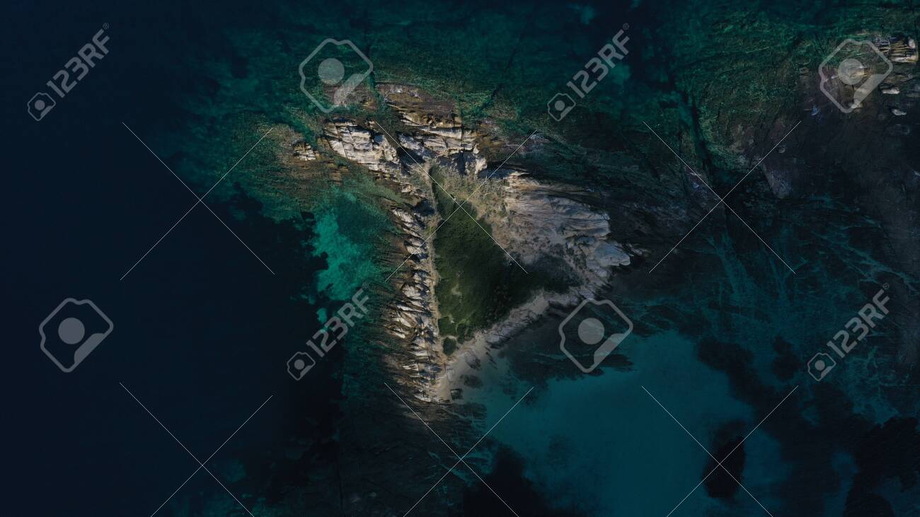 Aerial top down view of small island, islet in turquoise water of Aegean sea. Vourvourou beach, Halkidiki, Greece. - 143387876 Aerial top down view of small island, islet in turquoise water of Aegean sea. Vourvourou beach, Halkidiki, Greece. - 143387876