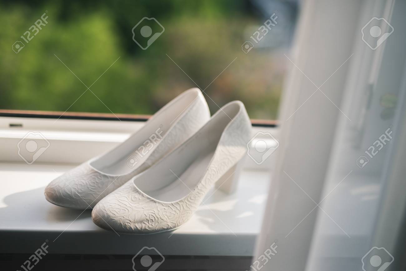 Elegant White Wedding Shoes For Women Near The Window Day Of