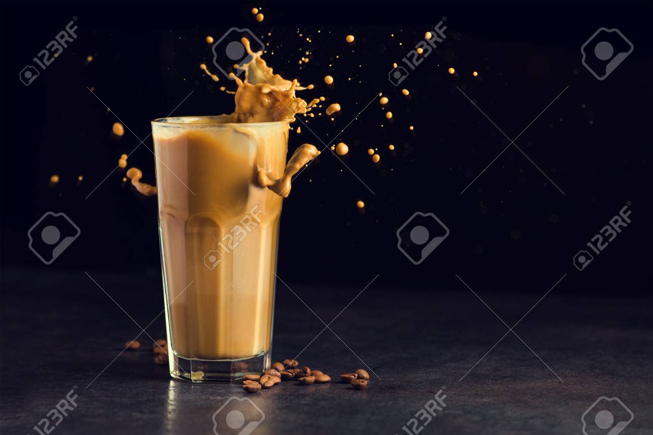 Iced latte coffee glass with splash on a black background - 96747237 Iced latte coffee glass with splash on a black background - 96747237