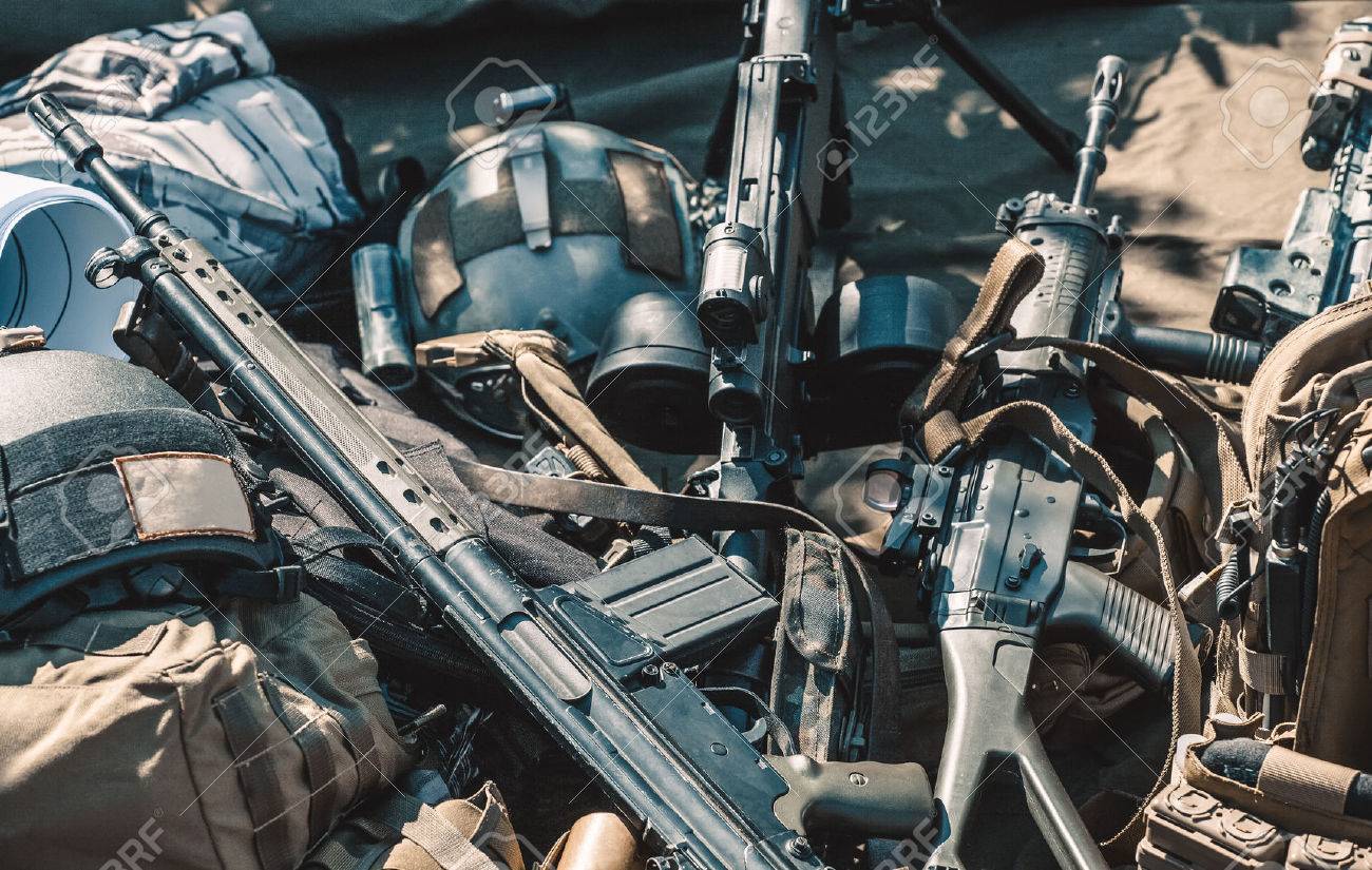 automatic machine, machine gun, helmet, body armor piled in a heap lie on the ground. - 62665816 automatic machine, machine gun, helmet, body armor piled in a heap lie on the ground. - 62665816