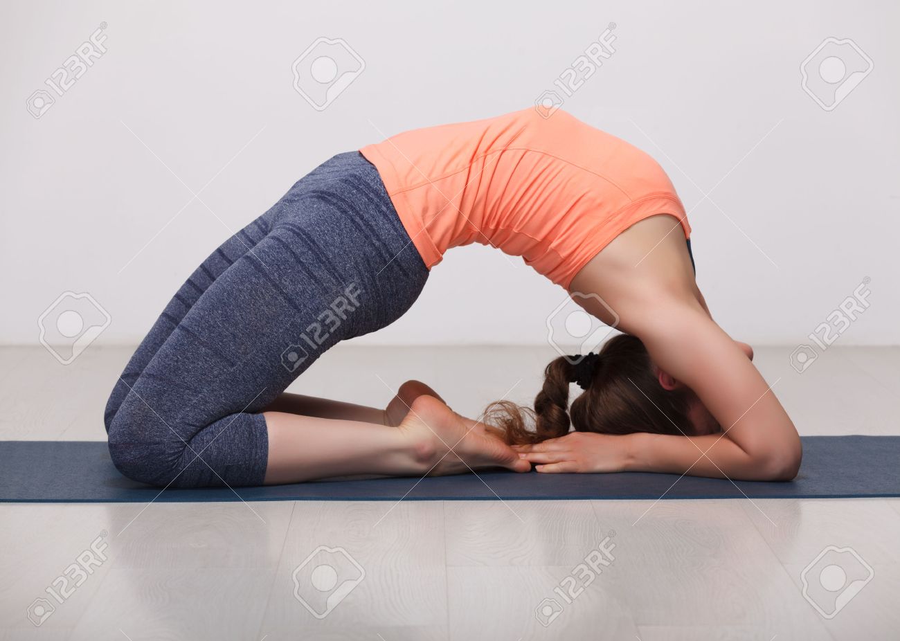 Beautiful sporty fit yogini woman practices yoga asana Kapotasana.. Beautiful sporty fit yogini woman practices yoga asana Kapotasana..