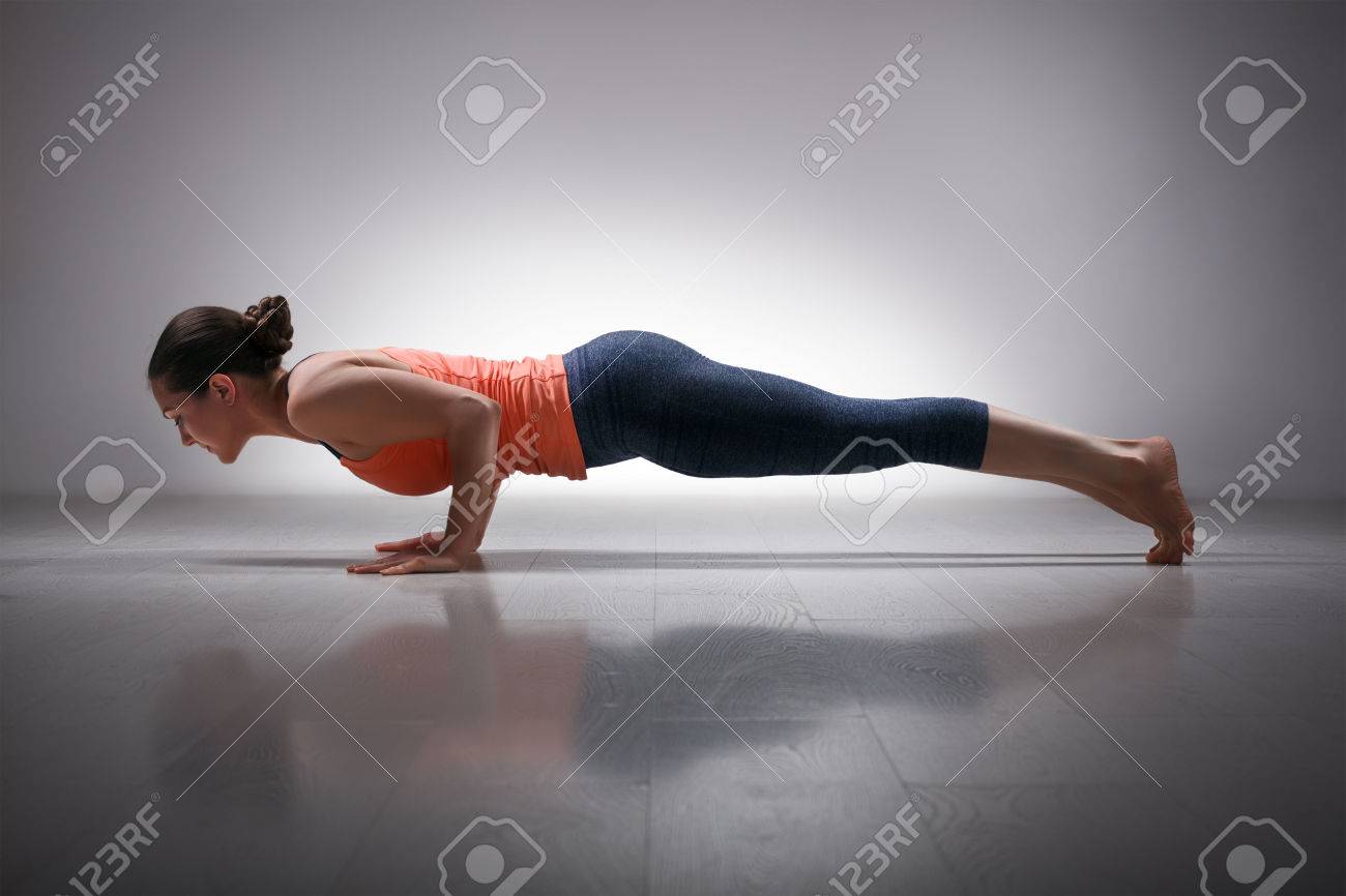 Beautiful sporty fit woman practices Ashtanga Vinyasa yoga Surya Namaskar Sun Salutation asana Chaturanga Dandasana - four-limbed staff pose - 48777299 Beautiful sporty fit woman practices Ashtanga Vinyasa yoga Surya Namaskar Sun Salutation asana Chaturanga Dandasana - four-limbed staff pose - 48777299