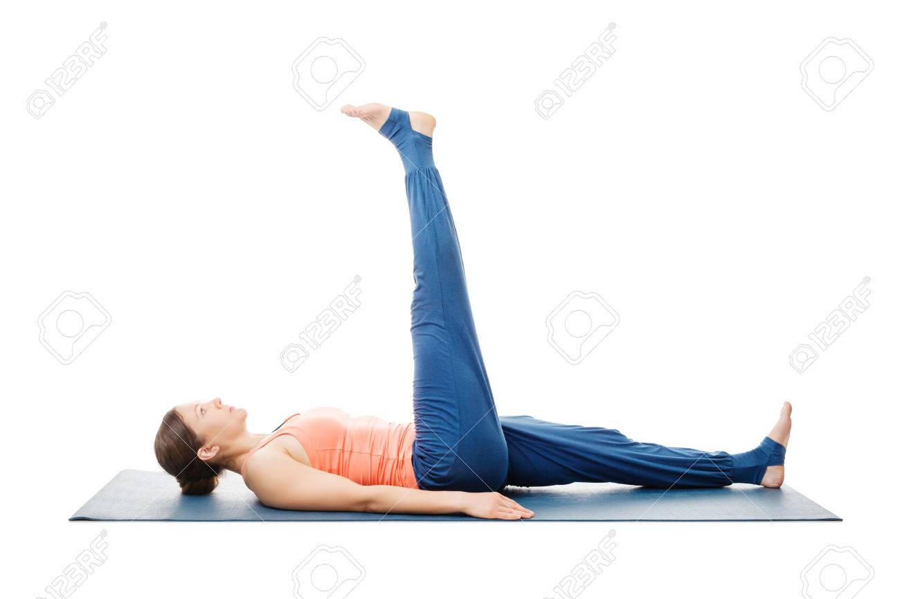 Woman doing yoga asana Uttanpadasana - lying down straight leg raise pose posture isolated on white background - 65820186 Woman doing yoga asana Uttanpadasana - lying down straight leg raise pose posture isolated on white background - 65820186