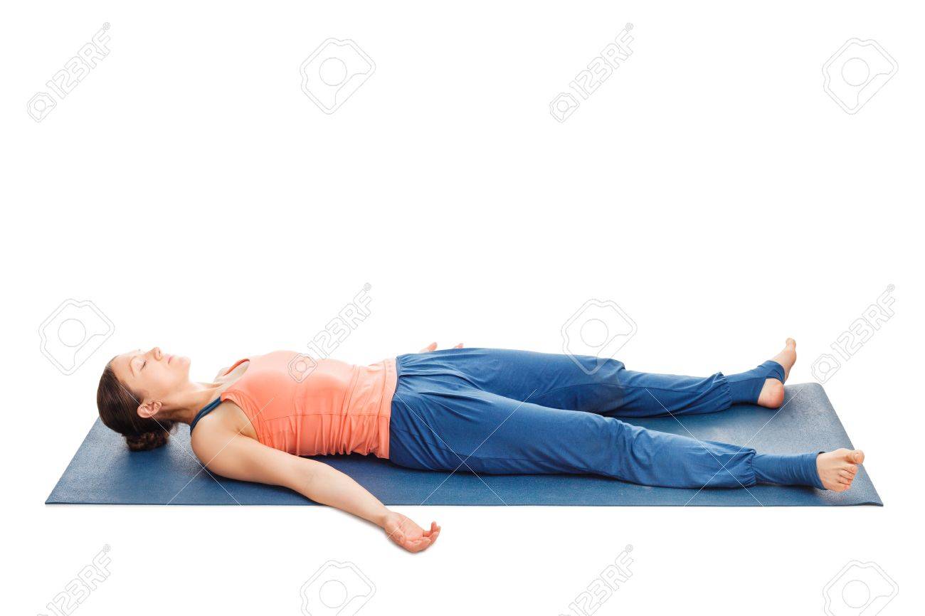 woman relaxes in yoga asana savasana corpse pose isolated on