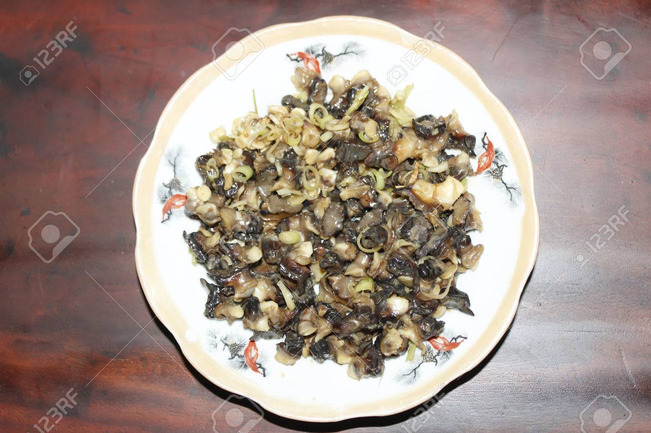 Closeup of eating the fried snails with stalks lemon grass - 41661073 Closeup of eating the fried snails with stalks lemon grass - 41661073