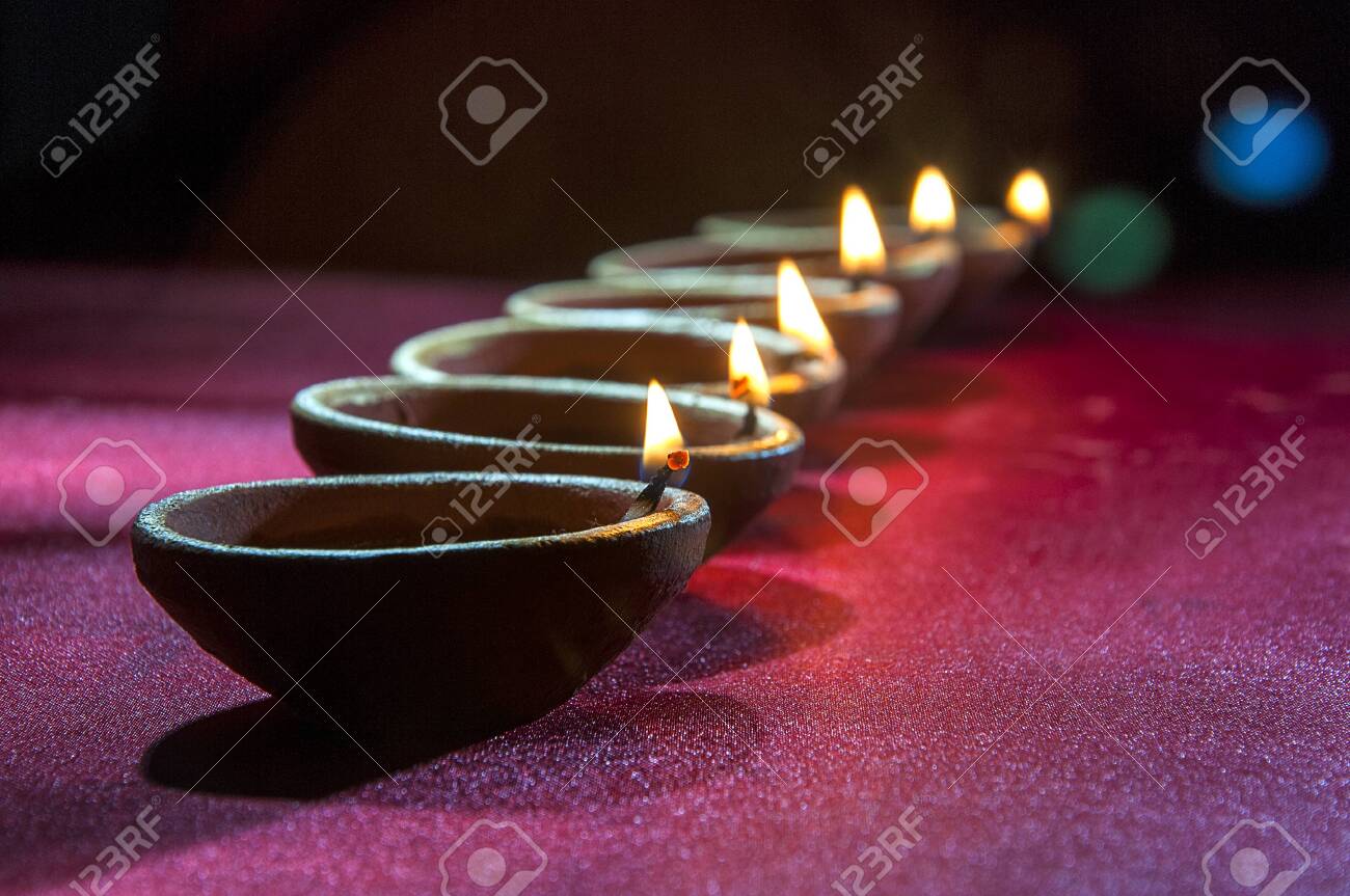 Clay diya lamps lit during Diwali Celebration. Greetings Card Design Indian Hindu Light Festival called Diwali - 134523622 Clay diya lamps lit during Diwali Celebration. Greetings Card Design Indian Hindu Light Festival called Diwali - 134523622