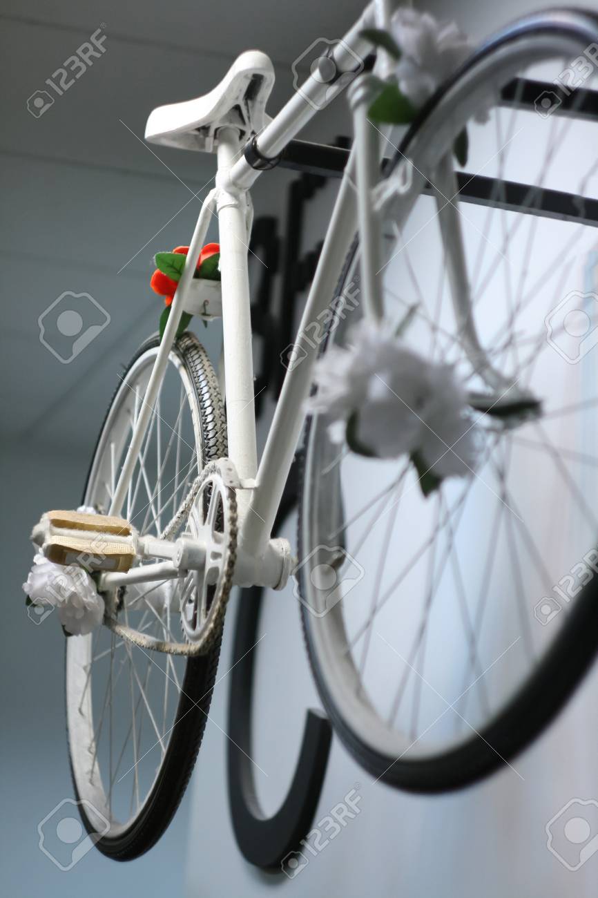 white retro vintage old style bicycle hanging on the wall stock